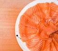 Closeup top view Slided Raw Salmon in white dish on wood blackground