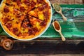 Closeup top view studio shot of Italian delicious tasty pepperoni pizza on white plate with oregano and red chilli power spices in Royalty Free Stock Photo