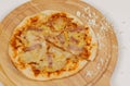 Closeup top view studio shot of tasty delicious Italian homemade mozzarella cheesy ham pineapple original Hawaiian pizza soft