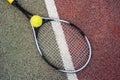 Closeup top view on tennis ball and racket racquet lying on acrylic tennis hard court surface with empty blank copy Royalty Free Stock Photo