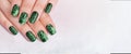 Closeup top view of two beautiful female hands with elegant classic professional fresh french green manicure Royalty Free Stock Photo