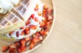 Closeup top view waffle strawberry ice cream on wood plate, selective focus