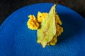 closeup topping of blue cake decorated with dried pear