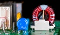 Closeup of toroidal core coil in electronic printed circuit board on black background