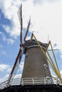 Closeup of tower, yellow start bars and blades at Korenbloem windmill