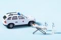Closeup of toy ambulance and paramedics helping a patient on a stretcher