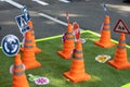 Closeup of toy traffic cones with traffic signs and symbols for educational purposes