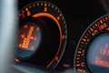 Closeup of the Toyota Auris fuel consumption sign in a car with orange lights