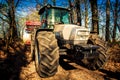 closeup tractor on soil road in spring forest