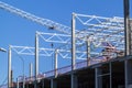 Closeup of Trade Center building during construction with steel frame shown against blue sky background. Retail shopping center Royalty Free Stock Photo