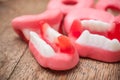 Traditional candies in shaped teeth on wooden backgro