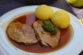 Closeup of traditional German roast pot Sauerbraten served with potato dumplings