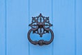 Closeup of traditional maltese door beater on blue door