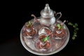 Closeup of a traditional Moorish mint tea service, with decorated glassware and silver teapot Royalty Free Stock Photo