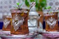 Closeup of a traditional Moorish mint tea service, with decorated glassware and silver teapot Royalty Free Stock Photo