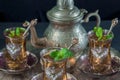 Closeup of a traditional Moorish mint tea service, with decorated glassware and silver teapot Royalty Free Stock Photo