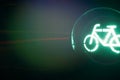 closeup on traffic light showing green bicycle symbol isolated at night with colorful dark background with moving light trail Royalty Free Stock Photo