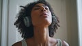 Closeup tranquil woman breathing deeply. African lady making exercises at home