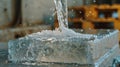 A closeup of a transparent gellike substance being poured into a mold on a construction site. material is a sustainable Royalty Free Stock Photo
