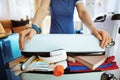 Closeup on traveller woman trying to close over packed suitcase