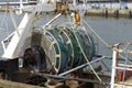 Closeup of trawl net wrapped around winch drum on the stern of a fishing boat Royalty Free Stock Photo