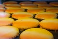 Closeup tray of orange iced sugar cookies at a bakery