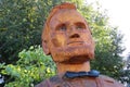 Closeup of tree stump carved into likeness of Abraham Lincoln.