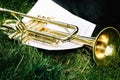 Closeup of a trumpet and sheet of music with notes. Royalty Free Stock Photo