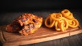 Closeup of Tsaty Cheeseburge sandwitches, cheese sticks and Onion rings on wooden table Royalty Free Stock Photo