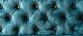 Close up of an electric blue tufted couch with gold buttons Royalty Free Stock Photo