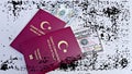 Closeup of Turkish passports with a pack of American dollars in the white background