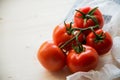 closeup twig five red tomatoes background wooden table