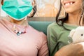 Closeup of two Asian teen girls hangout together with only one of them wearing face mask Royalty Free Stock Photo