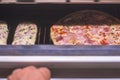 Closeup of two baguettes and a regular pizza cooking in the oven