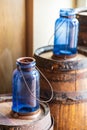 Closeup of two blue bottles on barrels Royalty Free Stock Photo