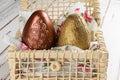 Closeup of two Easter eggs painted with edible paint on a basket of corn straw Royalty Free Stock Photo