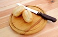 Closeup of two fresh petit pain with a bread knife