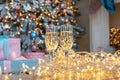 Closeup of two glasses of champagne on a Christmas New year background and decoration, light bokeh effect Royalty Free Stock Photo