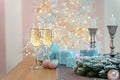 Closeup of two glasses of champagne surrounded by Christmas New year background and decoration, light bokeh effect Royalty Free Stock Photo