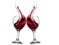 Closeup of two glasses of red wine with splashes on white background Royalty Free Stock Photo