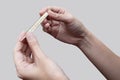 Closeup of two hands holding clinical thermometer and looking on it for checking temperature. Diagnosis and test COVID-19 Royalty Free Stock Photo