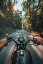 Closeup of two hands on motorcycle handlebars, motorcyclist on paved road