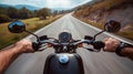 Closeup of two hands on motorcycle handlebars, motorcyclist on paved road