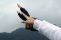 Closeup of two hands pointing at something or reaching out to the sky on gloomy sky background. Hope concept. Royalty Free Stock Photo