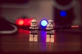 Closeup of two Lego Star Wars Soldiers holding an Audio plug