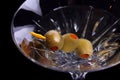 Martini with olives on black