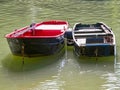 Closeup of two metal old boats in the muddy lake