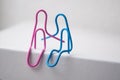 two paperclips sitting on white desk - love concept Royalty Free Stock Photo