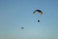 Closeup of two paragliders paragliding in the sky Royalty Free Stock Photo