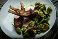 Closeup two pieces of grilled ribs with green vegetables Royalty Free Stock Photo